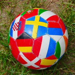 Fototapeta premium Red ball with various international flags on it with an interesting design