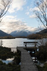 Naklejka premium Wooden boardwalk located near a body of water, providing a scenic view
