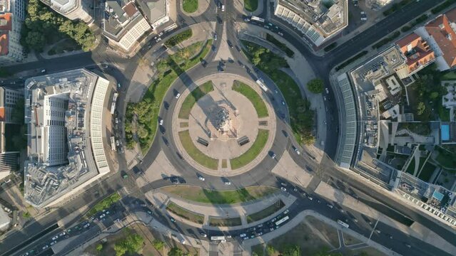 Drone shot over Marquis of Pombal Square with traffic and building around on a sunny day