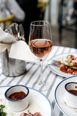 Still life shot of glass with rose wine on brunch table