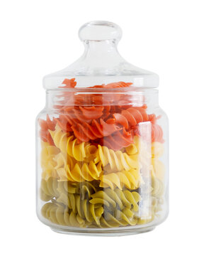 Glass jar with mixed green yellow and red fusilli pasta