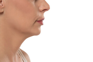 Closeup profile of a middle aged woman's face, mouth, nose and cheek on a white background