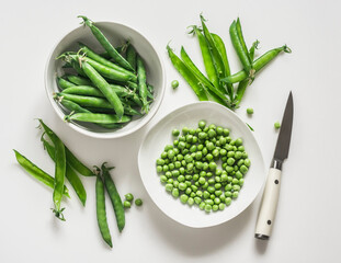 Young fresh green peas on a white background, top view