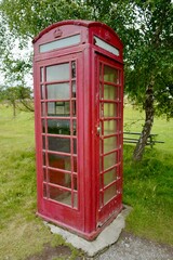 Red British telephone booth in the Highlands open air museum near Aviemore in Scotland