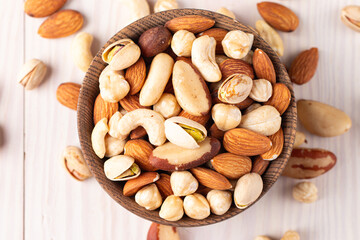Healthy mix nuts on wooden background. Almonds, hazelnuts, cashews, peanuts, pistachios, Brazilian nuts
