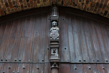 Holztor einer Burg mit Torbogen und Schnitzerei