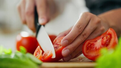 Preparation summer Mediterranean Greek salad. Close-up of female hands slicing tomatoes with knife on wooden cutting board, preparing vegetable salad. Chopped red tomatoes. Process of preparation