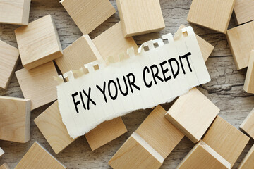 Fix your credit text on torn paper on wooden cubes. wooden background