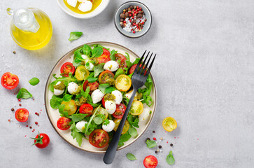 Caprese Salad with Cherry Tomatoes and Pesto Sauce over Bright Background