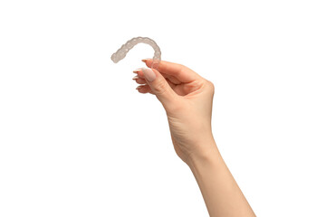 Transparent mouth guard in a woman's hand isolated on white background.