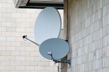 Satellite dish on wall of office building