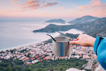 camping food - metal pot on the background of Oludeniz while travel by Lycian Way. Hiking cookware...