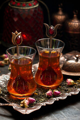 Delicious Turkish  tea in traditional  glass cups armudu  on metal tray