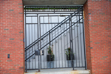 gates guard access, signifying boundaries, protection, and control. Barriers embrace both opportunity and restriction