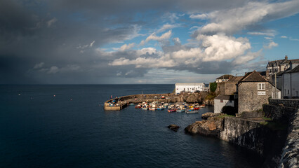 Coverack harbour landscape with rainbow and stormy skies