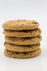 Wheat flour cookies with cherries and chocolate are on a white plate. Close-up.