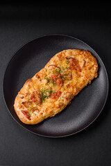 Delicious oven fresh flatbread pizza with cheese, tomatoes, sausage, salt and spices