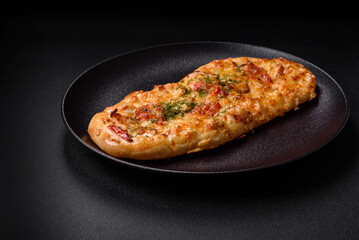 Delicious oven fresh flatbread pizza with cheese, tomatoes, sausage, salt and spices