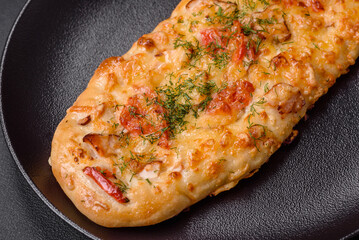 Delicious oven fresh flatbread pizza with cheese, tomatoes, sausage, salt and spices