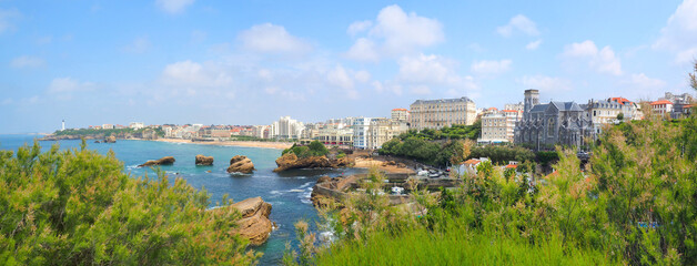 Panoramic view of Biarritz from the bell of the Atalaye plateau with in the foreground the fishermen's port dominated by the Sainte Eugenie church, then the large beach protected by its lighthouse - obrazy, fototapety, plakaty