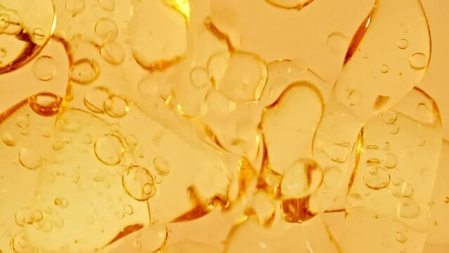 Macro Shot of Various Air Bubbles in Water Rising up on Light White Background. Liquid Gold Cream Gel Transparent Cosmetic Sample Texture With Bubbles. Concept of Clean and Purity. High quality FullHD