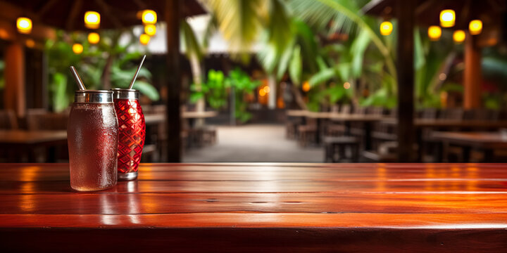Top of wooden table on blur background with palm tree, jungle or tropical cafe, coffee shop, bar or restaurant. Using for mock up template for display of your design.