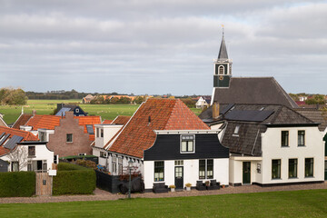 Village Oudeschild with the Zeemanskerk and picturesque houses on the Dutch Wadden island of Texel.