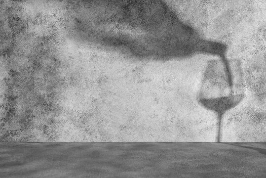 Abstract silhouette shadows pouring from a bottle of wine into a glass, gray concrete background. Mockup for product presentation.