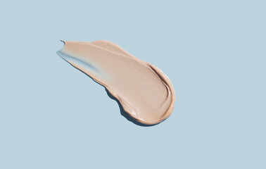 Cosmetic smear of cream texture on a blue background. Skin care.