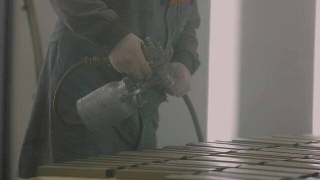  Someone painting metal. Someone painting wrought iron. Industry . slow motion .person working in a factory