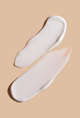 Cosmetic smear of cream texture on a beige background. Skin care.