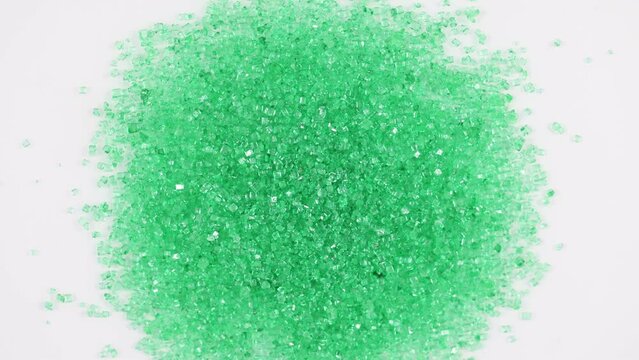Sparkly green sugar crystal sprinkles spinning clockwise