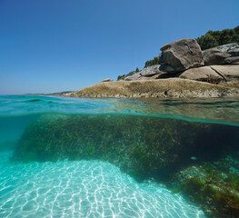 Boulders on the sea shore, split view over and under water surface, Atlantic coast in Spain, natural scene, Galicia, Rias Baixas