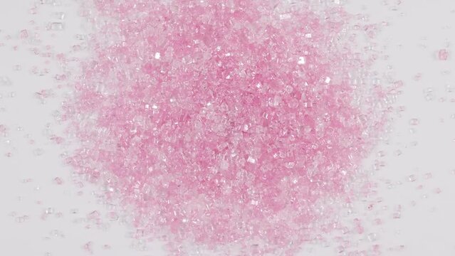 Sparkly pink sugar crystal sprinkles spinning clockwise