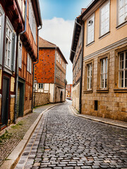 small town with old vintage small colored houses and old cobblestone pavement