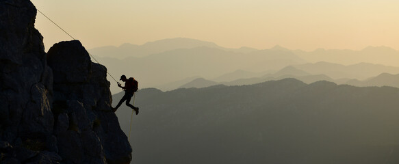 Young Man Doing Tough Rock Climbing
