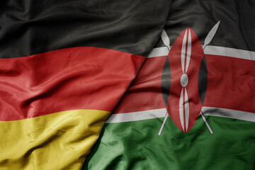 big waving realistic national colorful flag of germany and national flag of kenya .