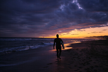 Fototapeta na wymiar person walking on the beach at sunset