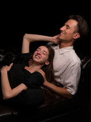 young couple white brunette man and white brunette woman with long hair on a dark background