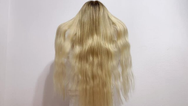 Beautiful long blonde shiny hair. Slim young girl in white clothes with luxurious straight white hair. Sexy blonde model girl with healthy bright hair. Lady with long hair. Treatment, hair care. 