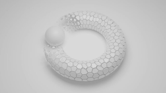 Loop 3d animation of a white bagel, torus, geometric figure. A torus of many hexagonal cells. The white sphere is in motion. The hexagonal elements of the torus disappear and appear