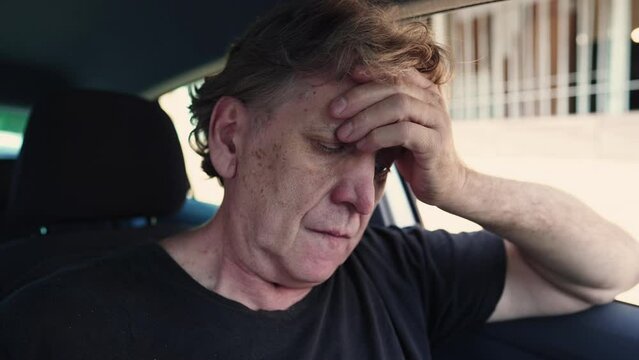 Preoccupied Senior Man Struggling with Depression and Solitude Inside Car, Quiet Despair