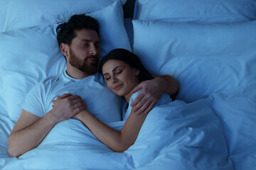 Lovely couple sleeping together in bed at night, top view - Powered by Adobe