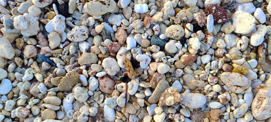 ASIA, INDONESIA June 2023, small rocks on white sand