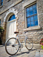 Fototapeta na wymiar Vintage Charm: White Bicycle by an Antique Building