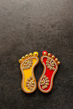 Dhanteras goddess golden feet. Thali for festival celebration to worship. Laxmi Charan Paduka Diwali festival celebration background. Maa Lakshmi footprint Hindu Pooja Material.