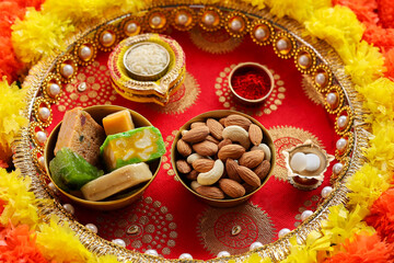 Top view of almonds badam on Diwali festival background. Indian sweet dessert mithai festival dish...