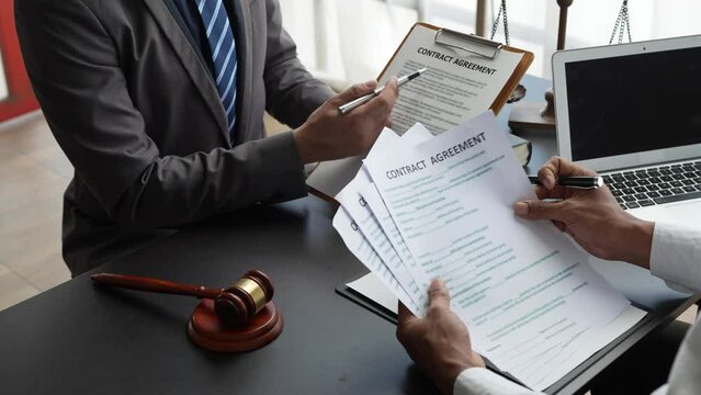 Attorneys or lawyers who are reading the statute of limitations Consultation between male lawyers and business clients, tax and legal and legal services firms.
