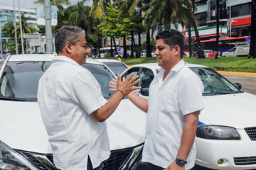 latin couple of taxi drivers men with car on background at city street in Mexico in Latin America, Hispanic people working
