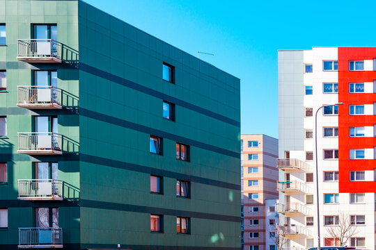 A Newly Built Building In Nice Bright Colors With Apartments For Sale.Red Orange And Green Block Of Flats.Newly Finished Modern Style Apartment Building In Freshly Renovated Residential Area.